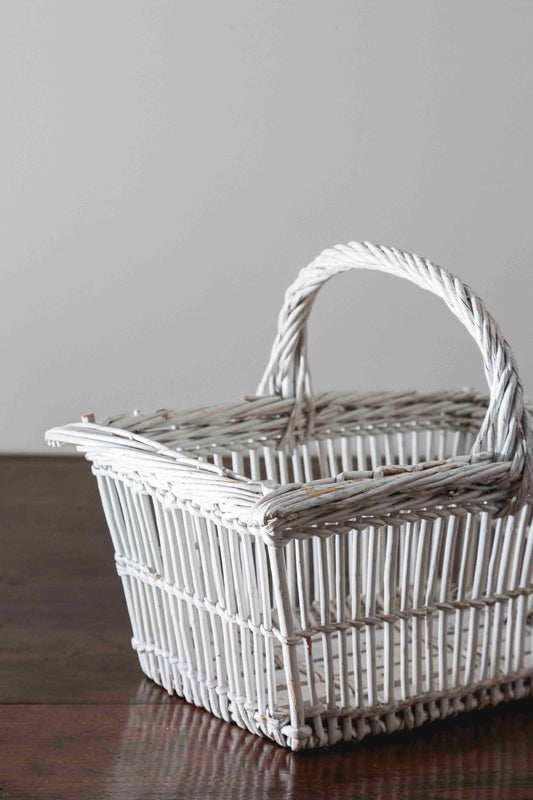 Cesta blanca antigua de mimbre con asa