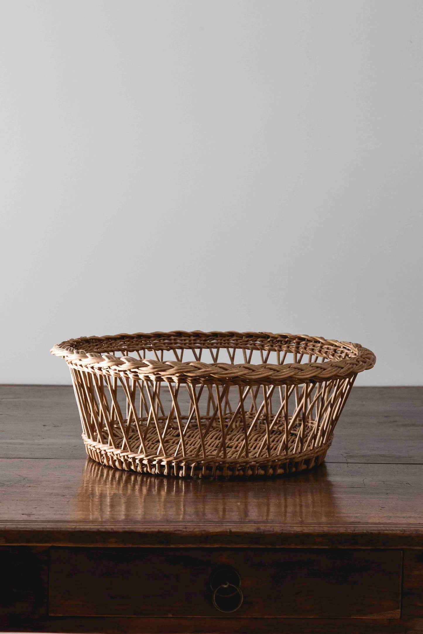 Antique round braided wicker basket