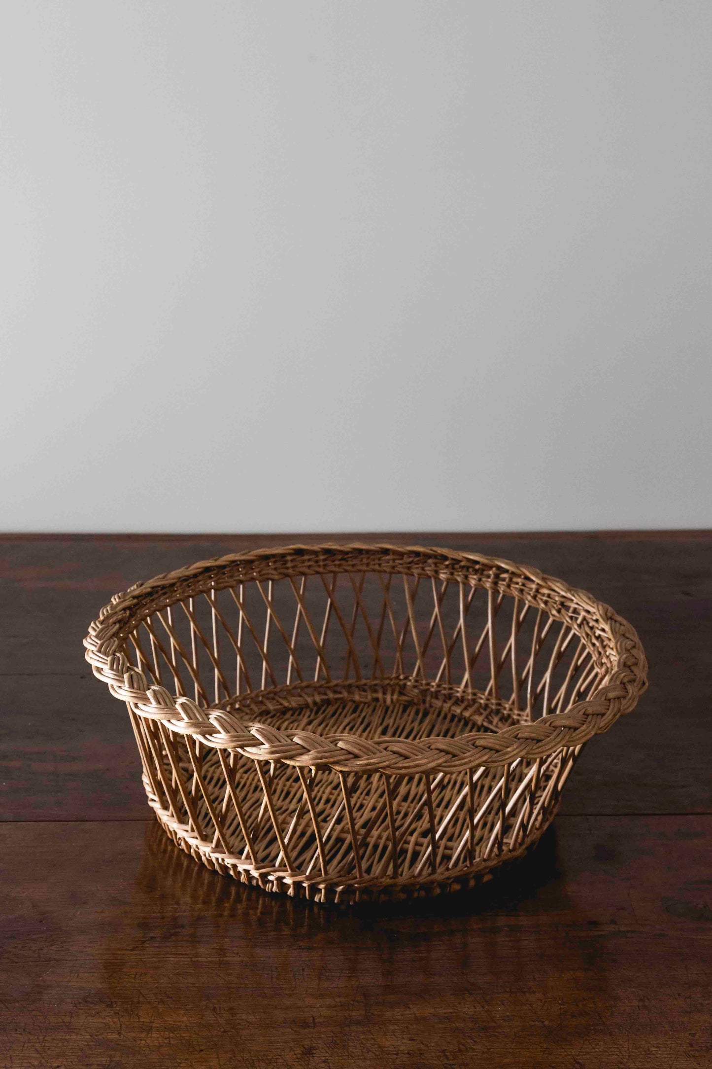 Antique round braided wicker basket