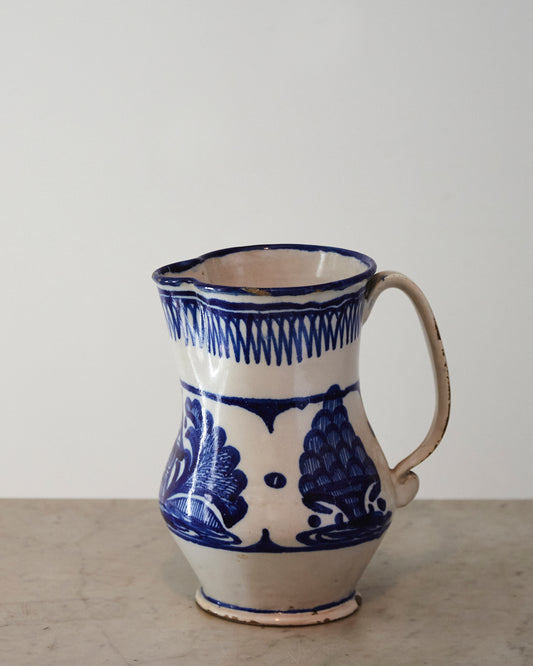 Jug with flowers and blue fruits